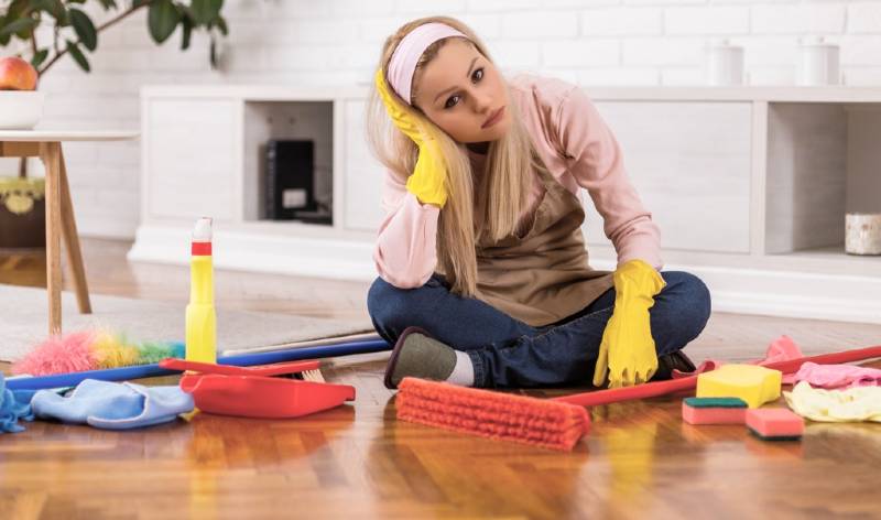 Women sitting on floor with cleaning tools