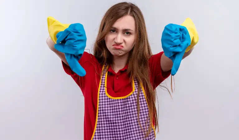 Woman in red dress and yellow-blue gloves showing her thumps down.