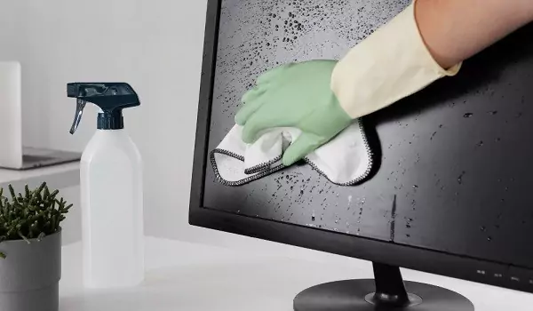 cropped picture of a person cleaning a computer screen