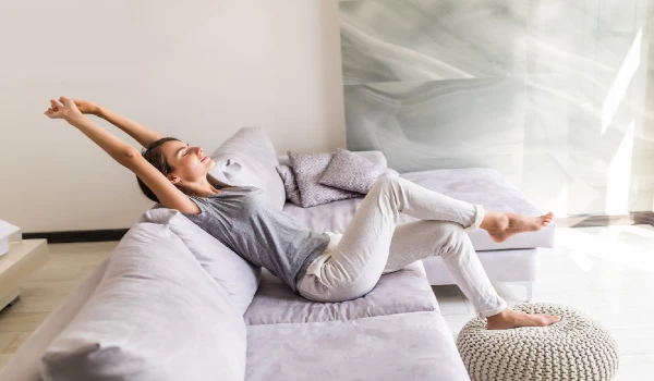 Smiling young woman relax lying on couch